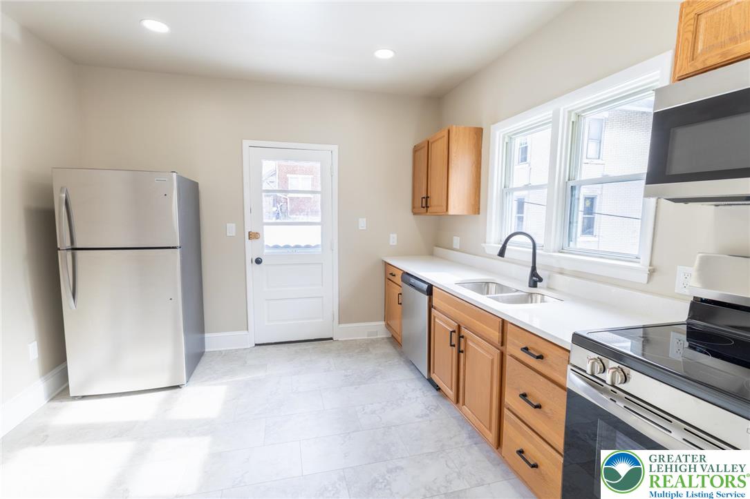 706 Main Street, Unit 2 Bethlehem, PA 18018 - Photo 18 of 20 a kitchen with stainless steel appliances a refrigerator sink and cabinets