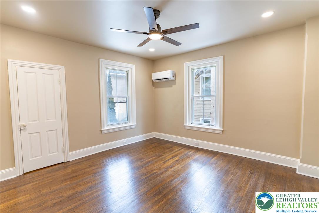 706 Main Street, Unit 2 Bethlehem, PA 18018 - Photo 3 of 20 a view of an empty room with wooden floor and a window