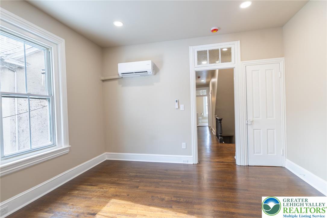 706 Main Street, Unit 2 Bethlehem, PA 18018 - Photo 8 of 20 a view of an empty room with wooden floor and a window