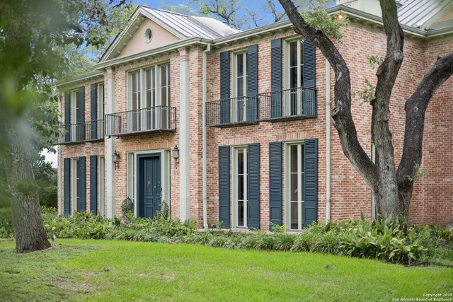 a view of an empty room with a fireplace and a window