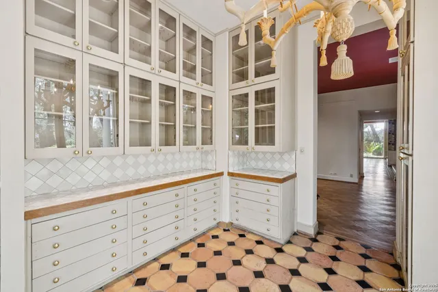 a kitchen with granite countertop a white cabinets and sink