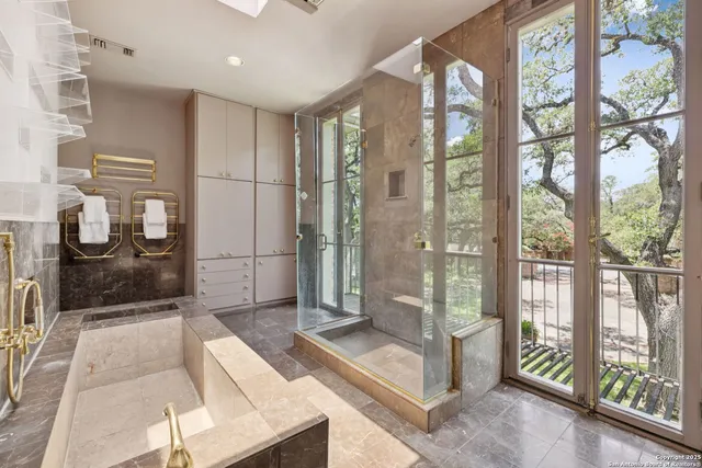 a front view of a house with a tree