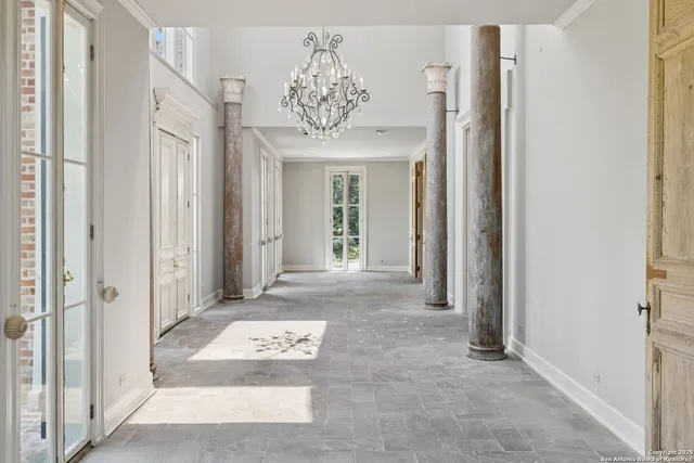 a view of an empty room with a fireplace and a window