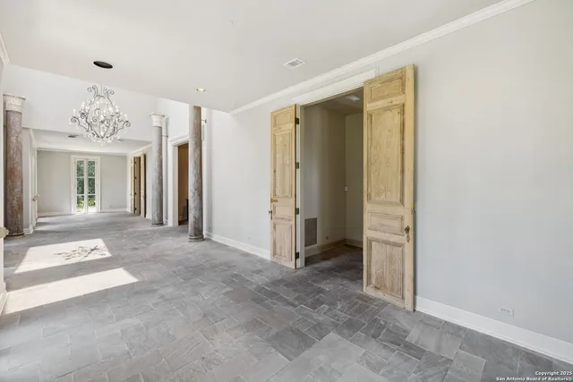 a view of an entryway with a floor to ceiling window and wooden floor