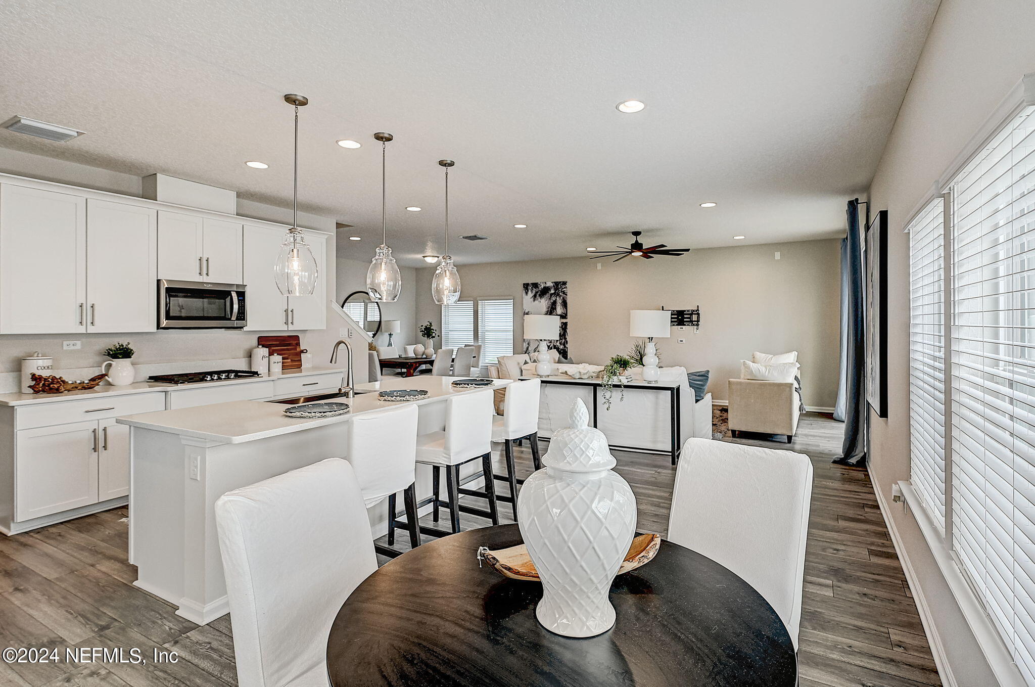 433 Watervale Drive St. Augustine, FL 32092 - Photo 16 of 66 a living room with stainless steel appliances kitchen island granite countertop furniture and wooden floor