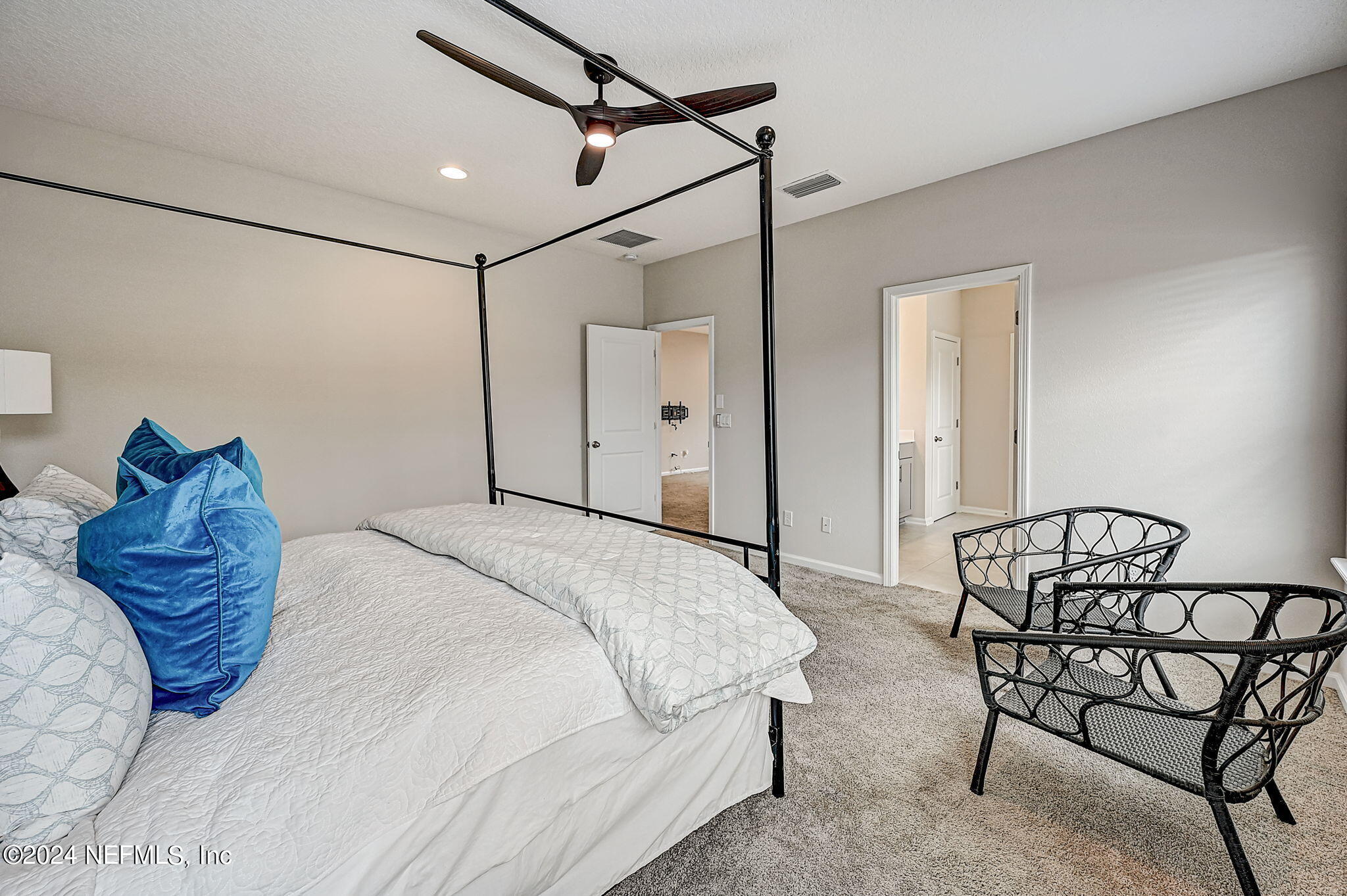 433 Watervale Drive St. Augustine, FL 32092 - Photo 26 of 66 a bedroom with a bed a chandelier and a chair