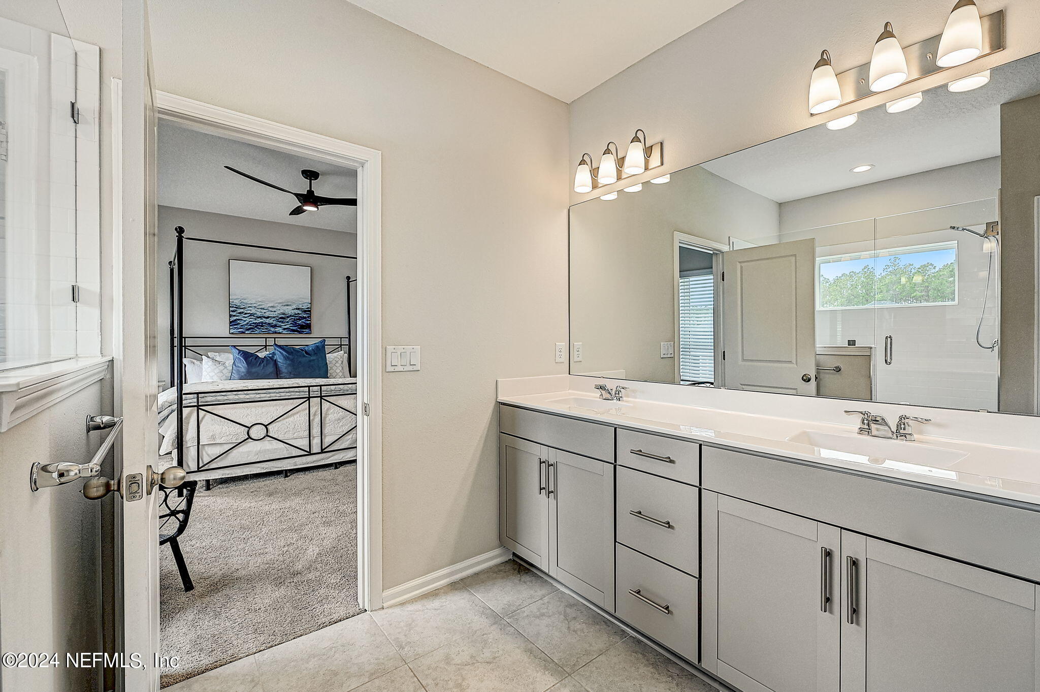 433 Watervale Drive St. Augustine, FL 32092 - Photo 27 of 66 a en suite bathroom with a double vanity sink a mirror a vanity and a bathtub