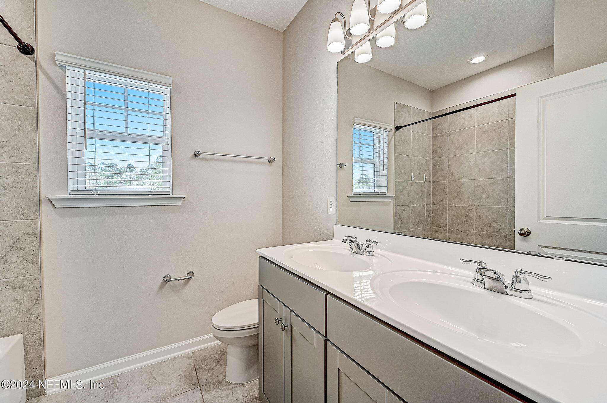 433 Watervale Drive St. Augustine, FL 32092 - Photo 32 of 66 a bathroom with a sink a toilet and mirror