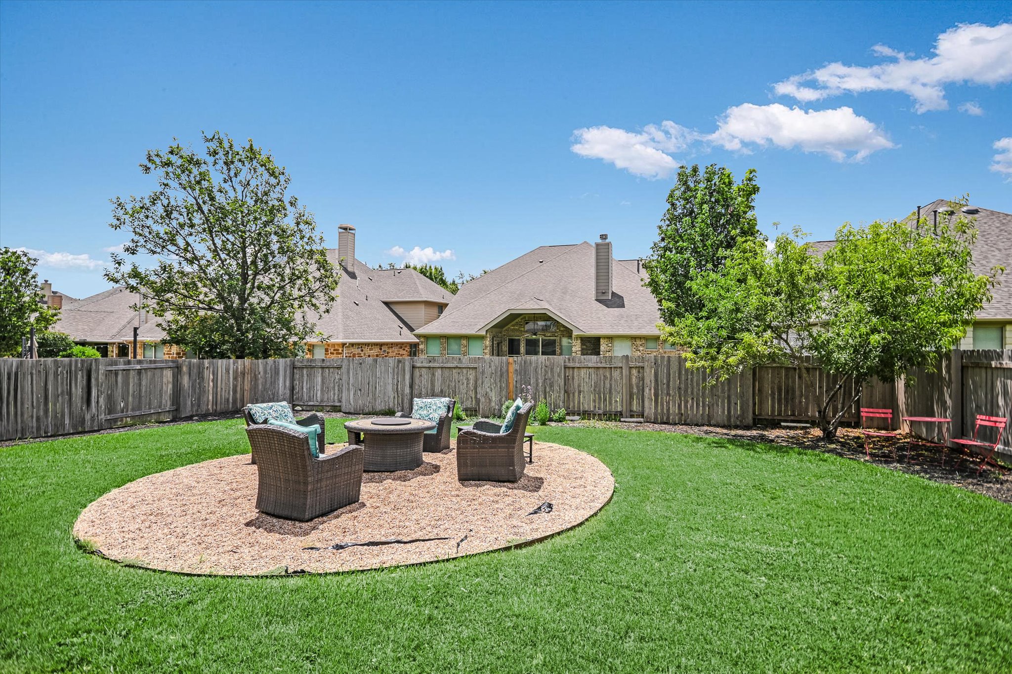 4623 Chestnut Meadows Bend Georgetown, TX 78626 - Photo 28 of 30 a view of a backyard with table and chairs potted plants and wooden fence