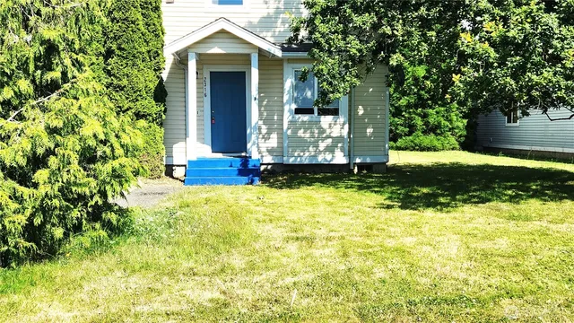 a front view of a house with a yard