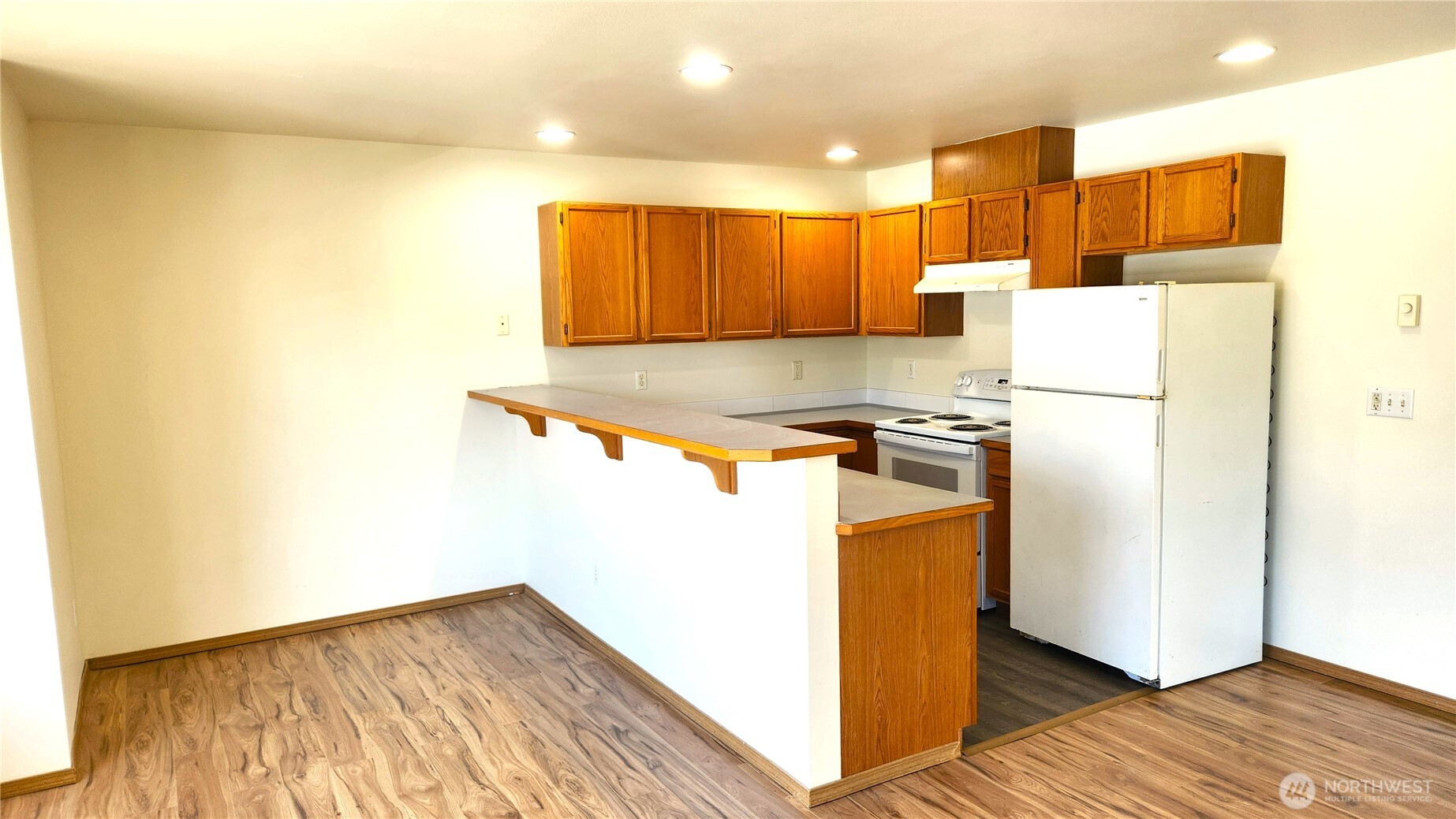 2316 Xenia Street, Unit 2316 Bellingham, WA 98229 - Photo 4 of 23 a kitchen with a refrigerator and a stove top oven
