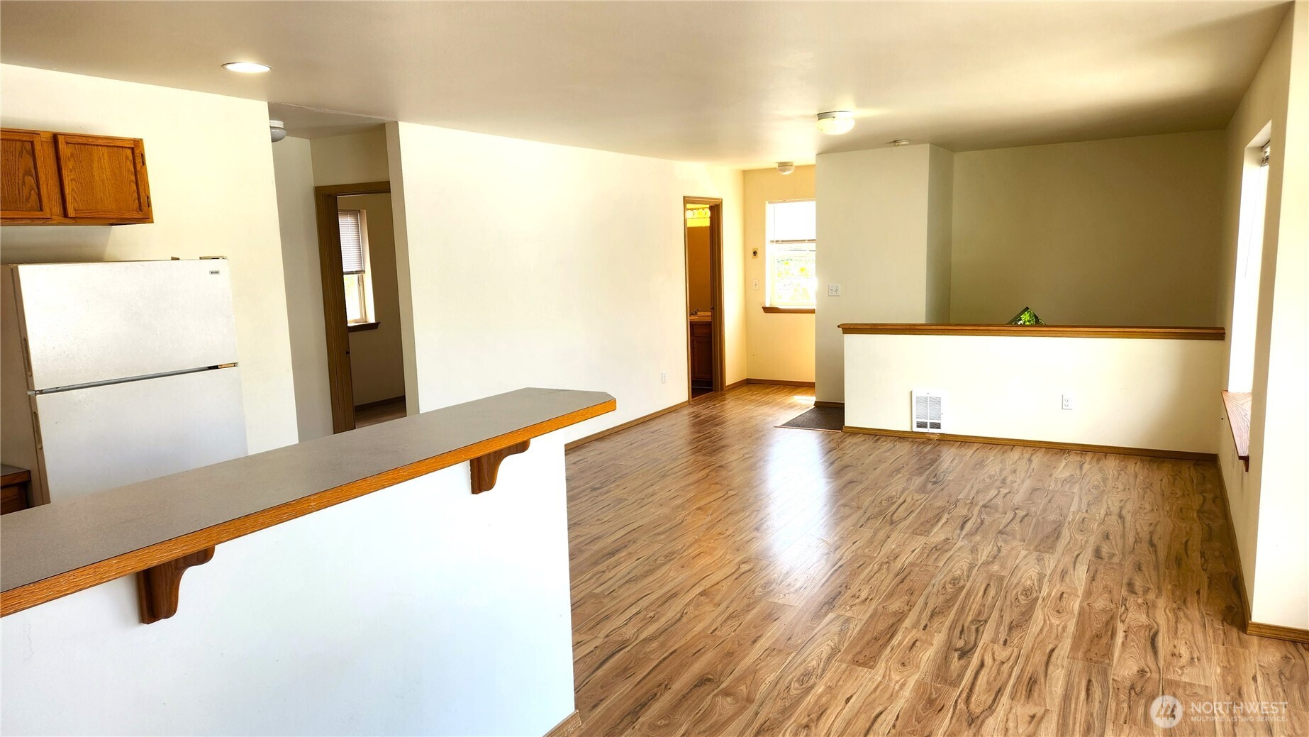 2316 Xenia Street, Unit 2316 Bellingham, WA 98229 - Photo 5 of 23 a view of a kitchen with kitchen island a sink wooden floor and a refrigerator