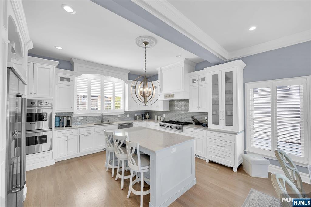 6 Capstan Road Waretown, NJ 08758 - Photo 11 of 47 a kitchen with stainless steel appliances a stove a sink a oven a center island and a refrigerator
