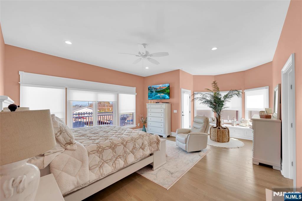 6 Capstan Road Waretown, NJ 08758 - Photo 24 of 47 a bedroom with a large bed and a chandelier
