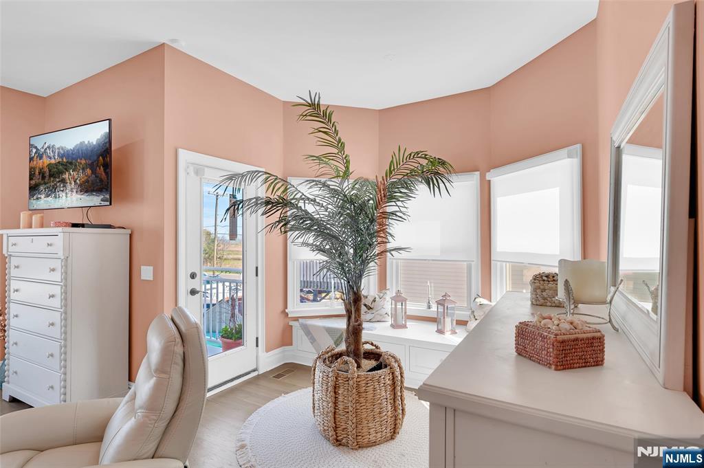 6 Capstan Road Waretown, NJ 08758 - Photo 25 of 47 a living room with furniture a large window and a potted plant
