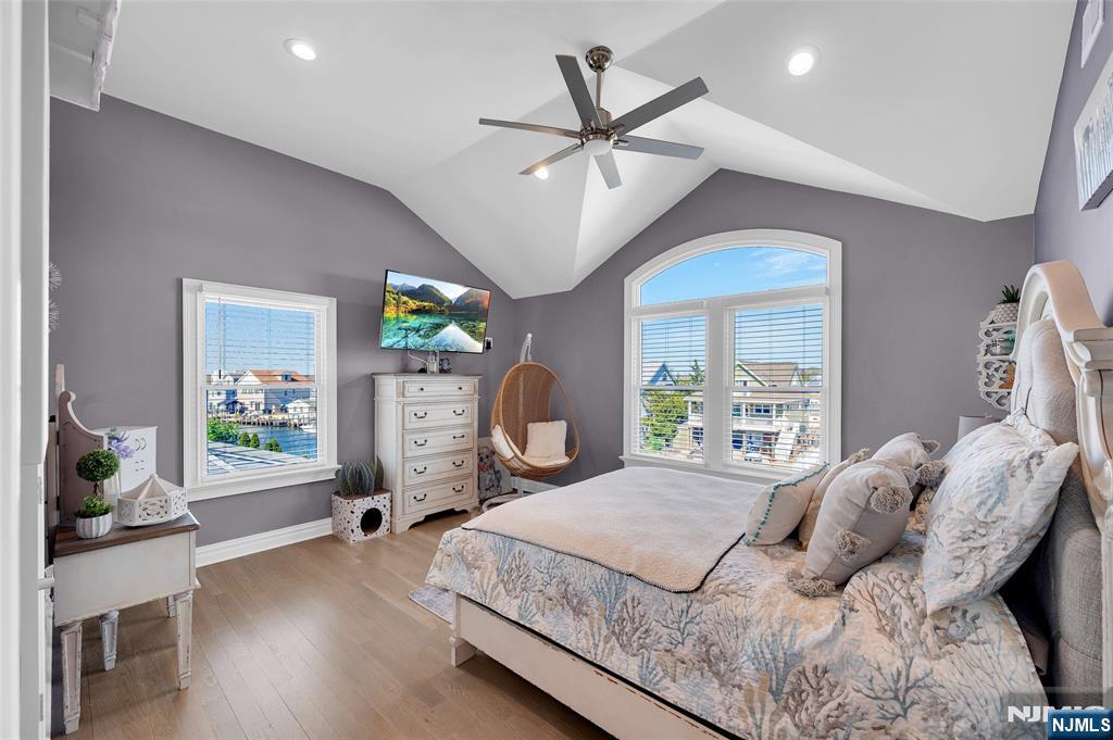 6 Capstan Road Waretown, NJ 08758 - Photo 29 of 47 a bedroom with a large bed and a chandelier