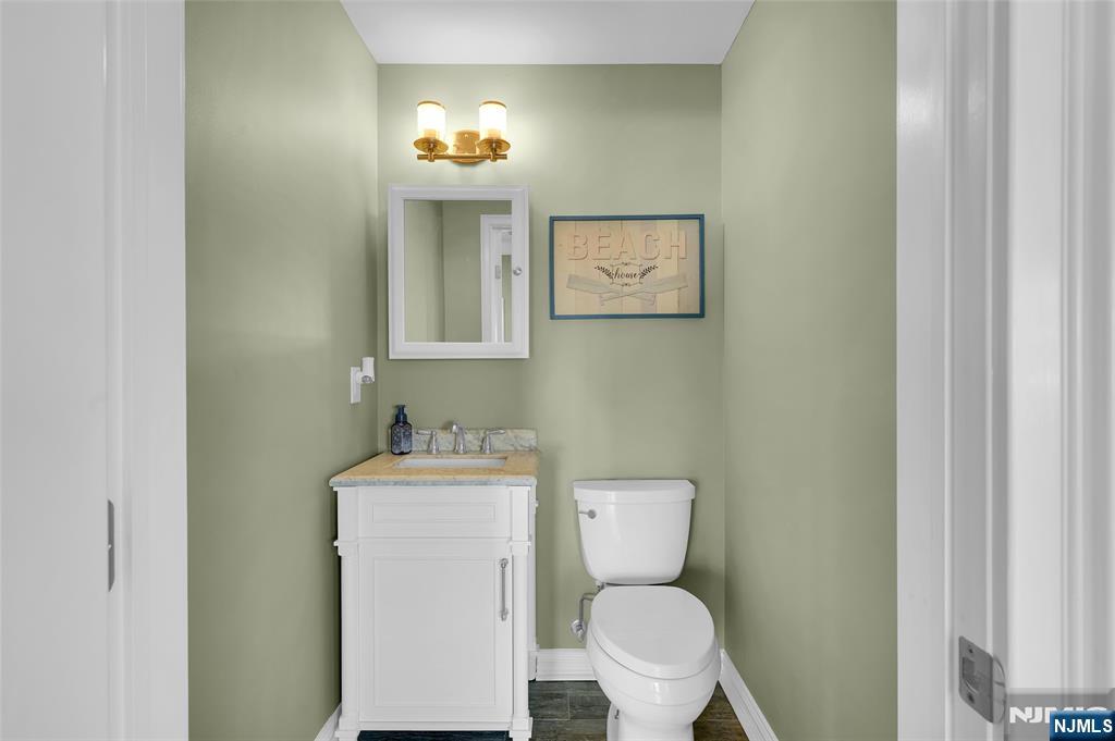 6 Capstan Road Waretown, NJ 08758 - Photo 33 of 47 a bathroom with a toilet sink vanity and mirror