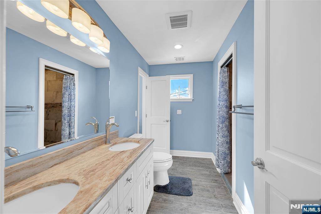 6 Capstan Road Waretown, NJ 08758 - Photo 34 of 47 a spacious bathroom with a granite countertop sink a toilet and shower