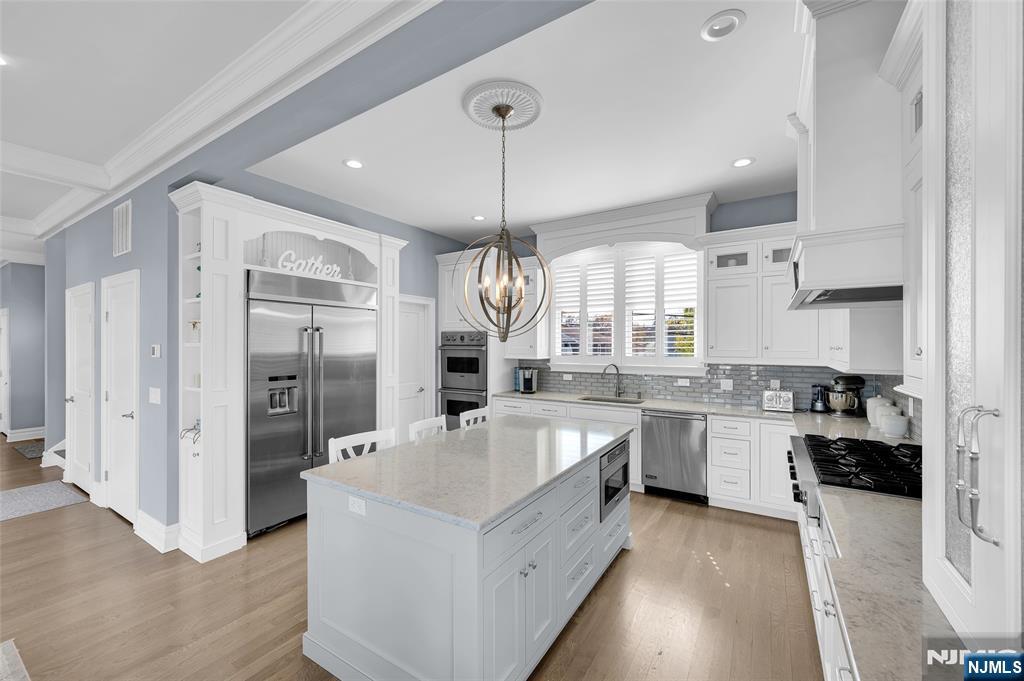 6 Capstan Road Waretown, NJ 08758 - Photo 10 of 47 a large white kitchen with a large window and stainless steel appliances