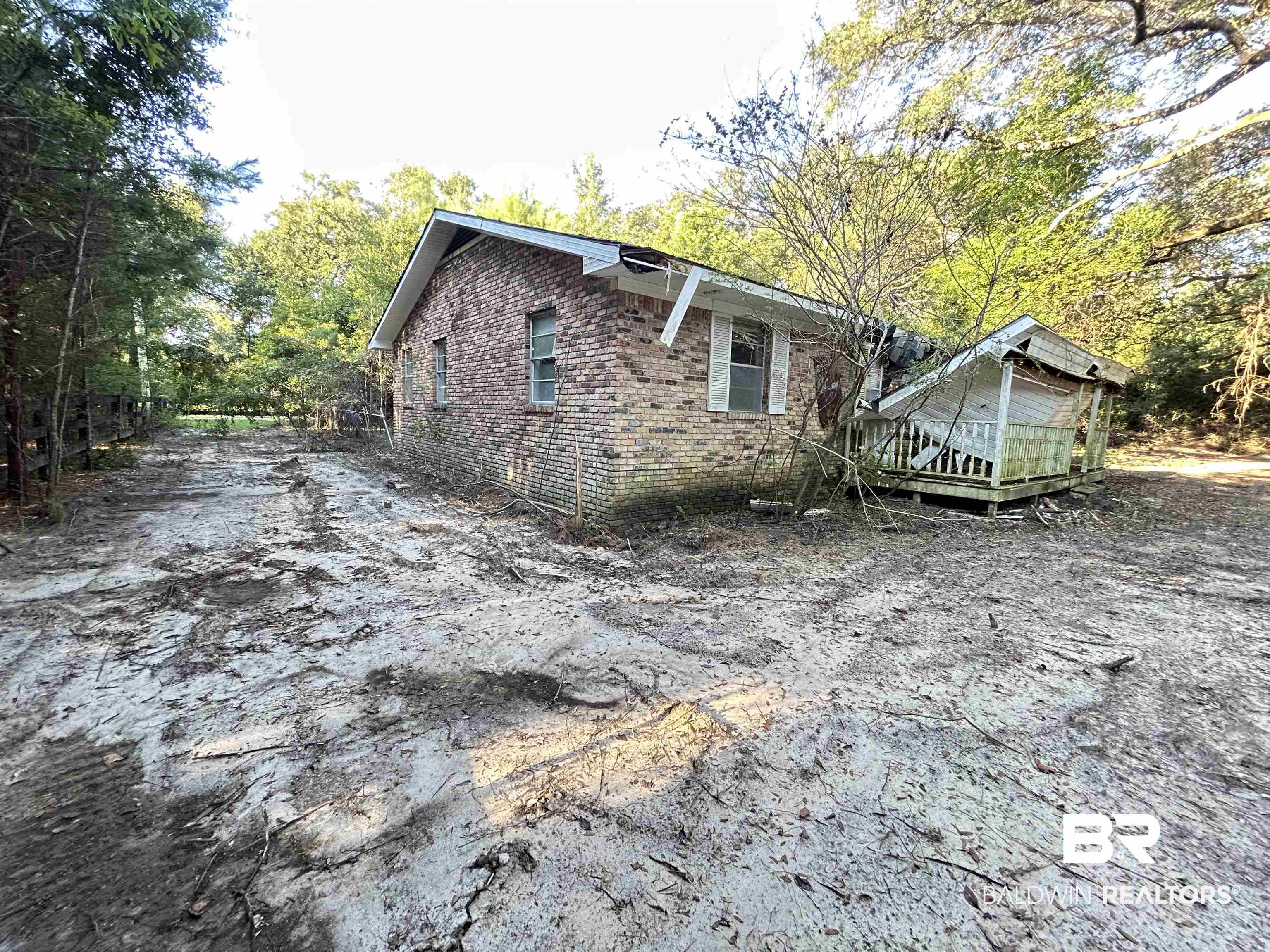 16775 Old Pierce Road Fairhope, AL 36532 - Photo 2 of 4 View of property exterior featuring brick siding and a wooden deck