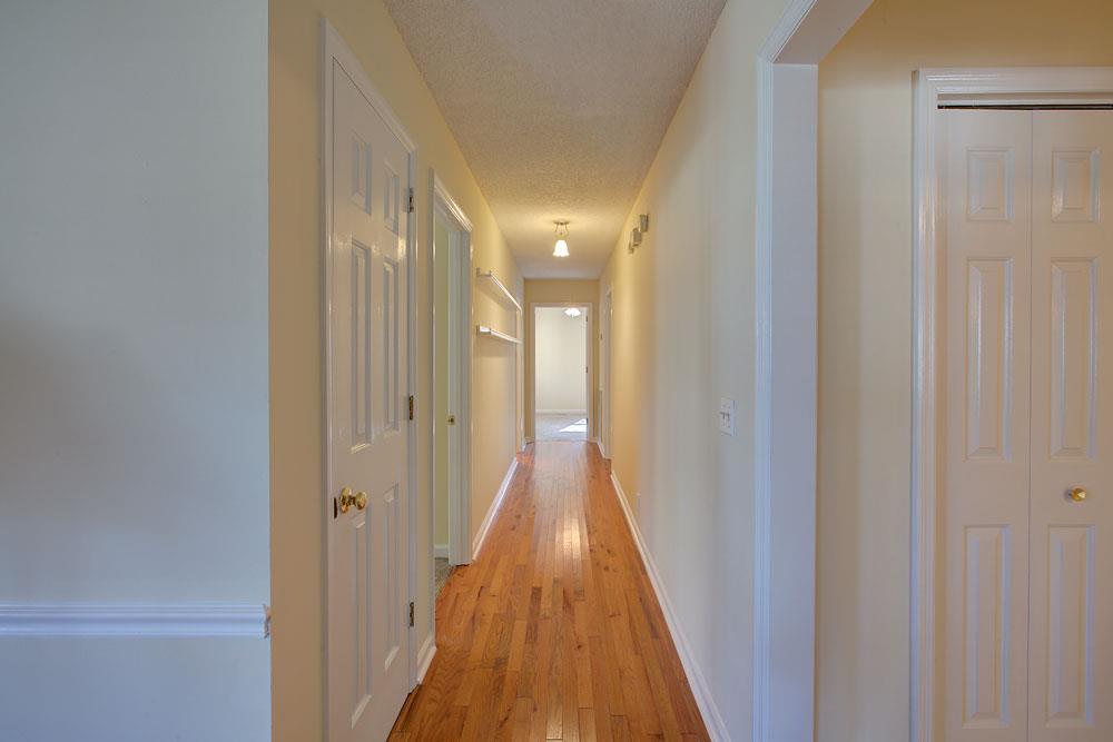 256 Pleasant Run Road Smyrna, TN 37167 - Photo 14 of 28 Hallway to downstairs bedrooms. Large storage & coat closet to the left under staircase.