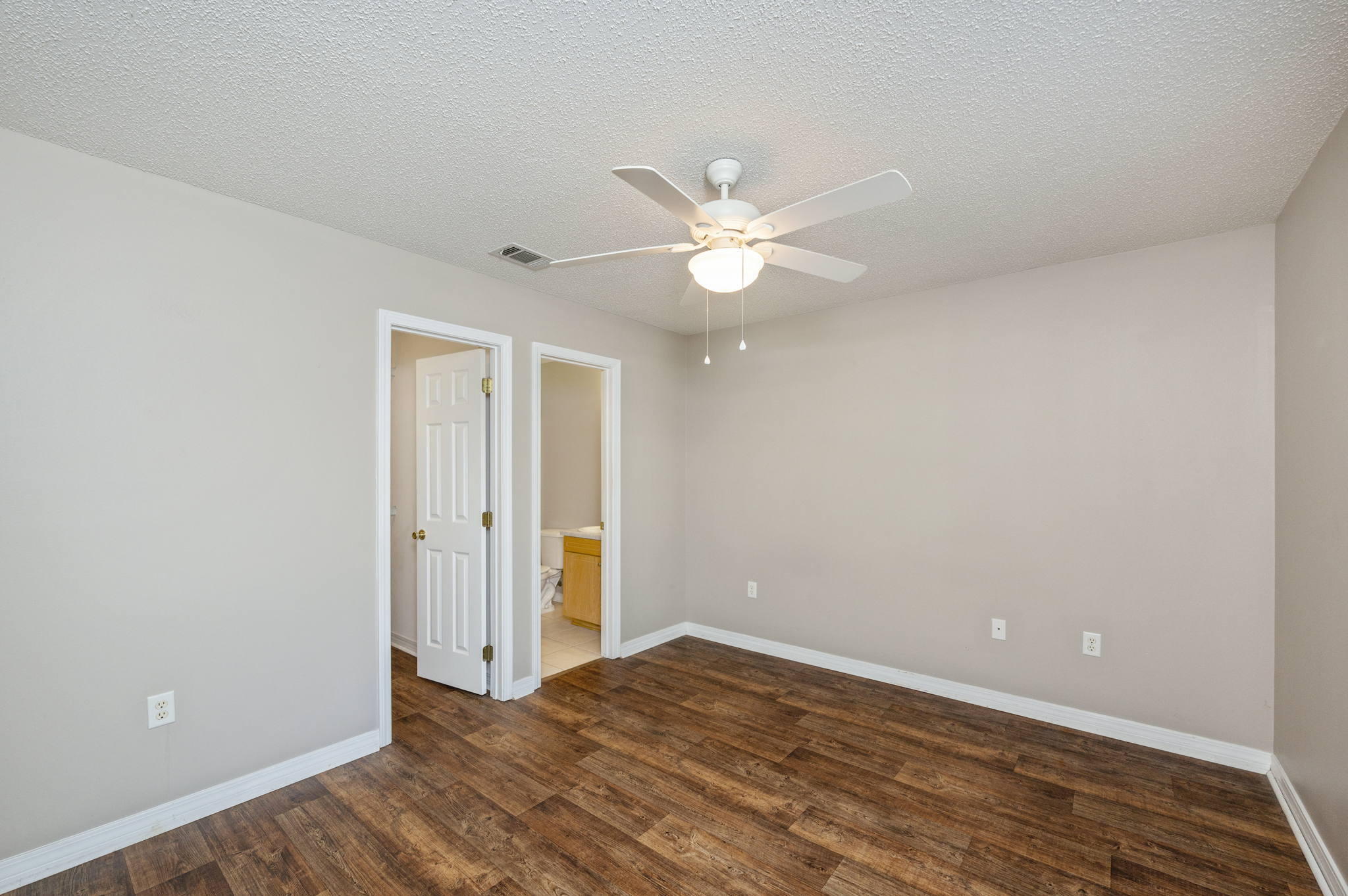 6235 Winstead Road Crestview, FL 32539 - Photo 12 of 31 wooden floor in an empty room with a window