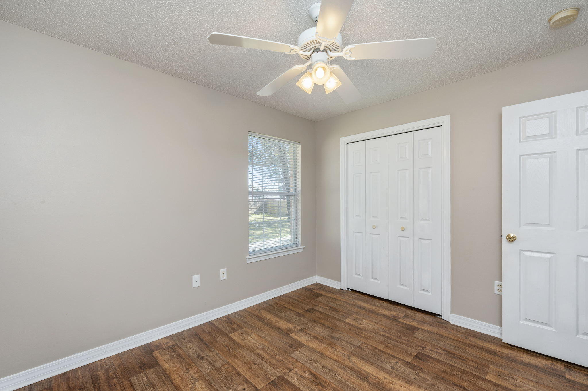 6235 Winstead Road Crestview, FL 32539 - Photo 20 of 31 wooden floor in an empty room with a window