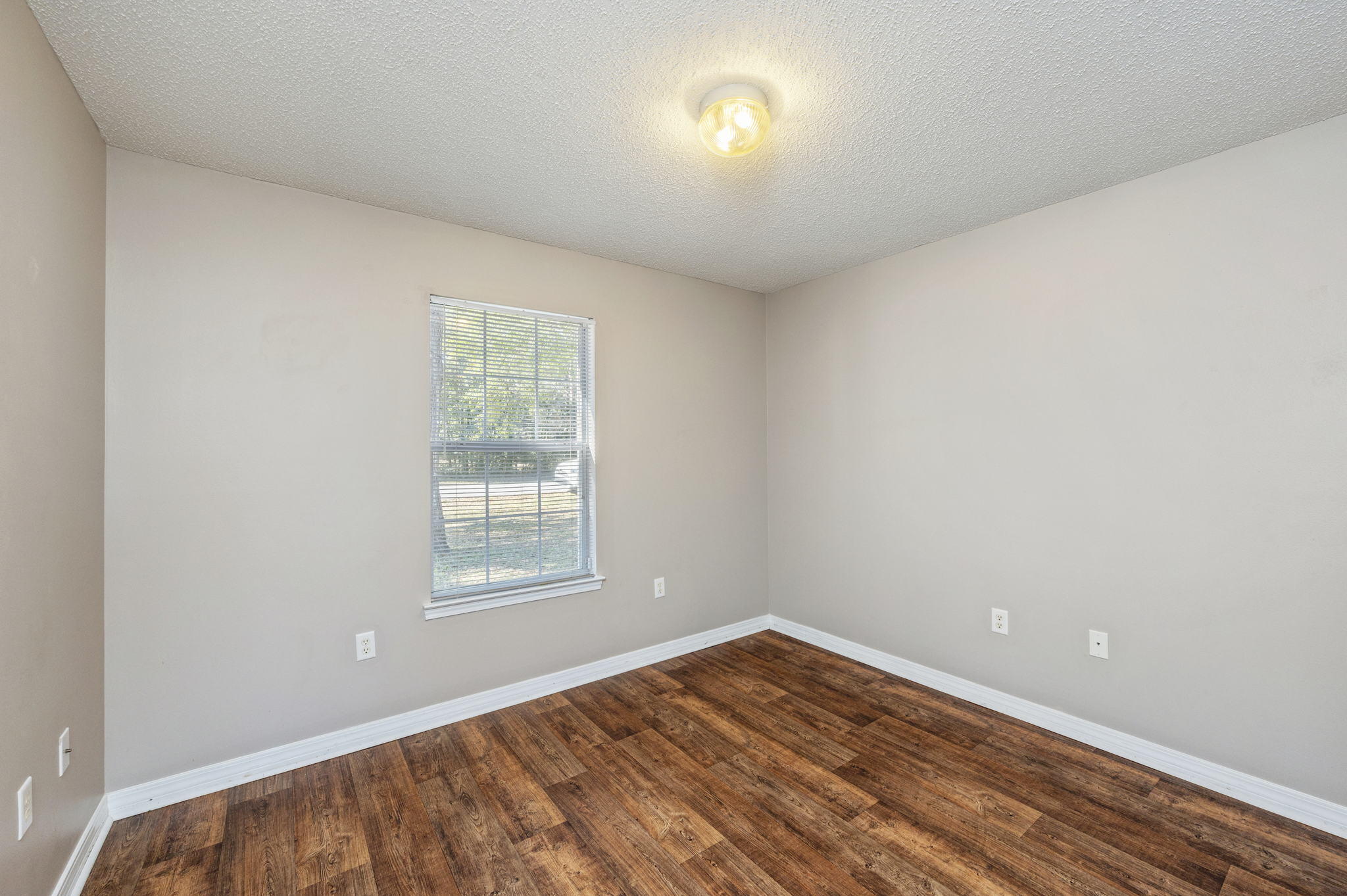 6235 Winstead Road Crestview, FL 32539 - Photo 21 of 31 wooden floor in an empty room with a window