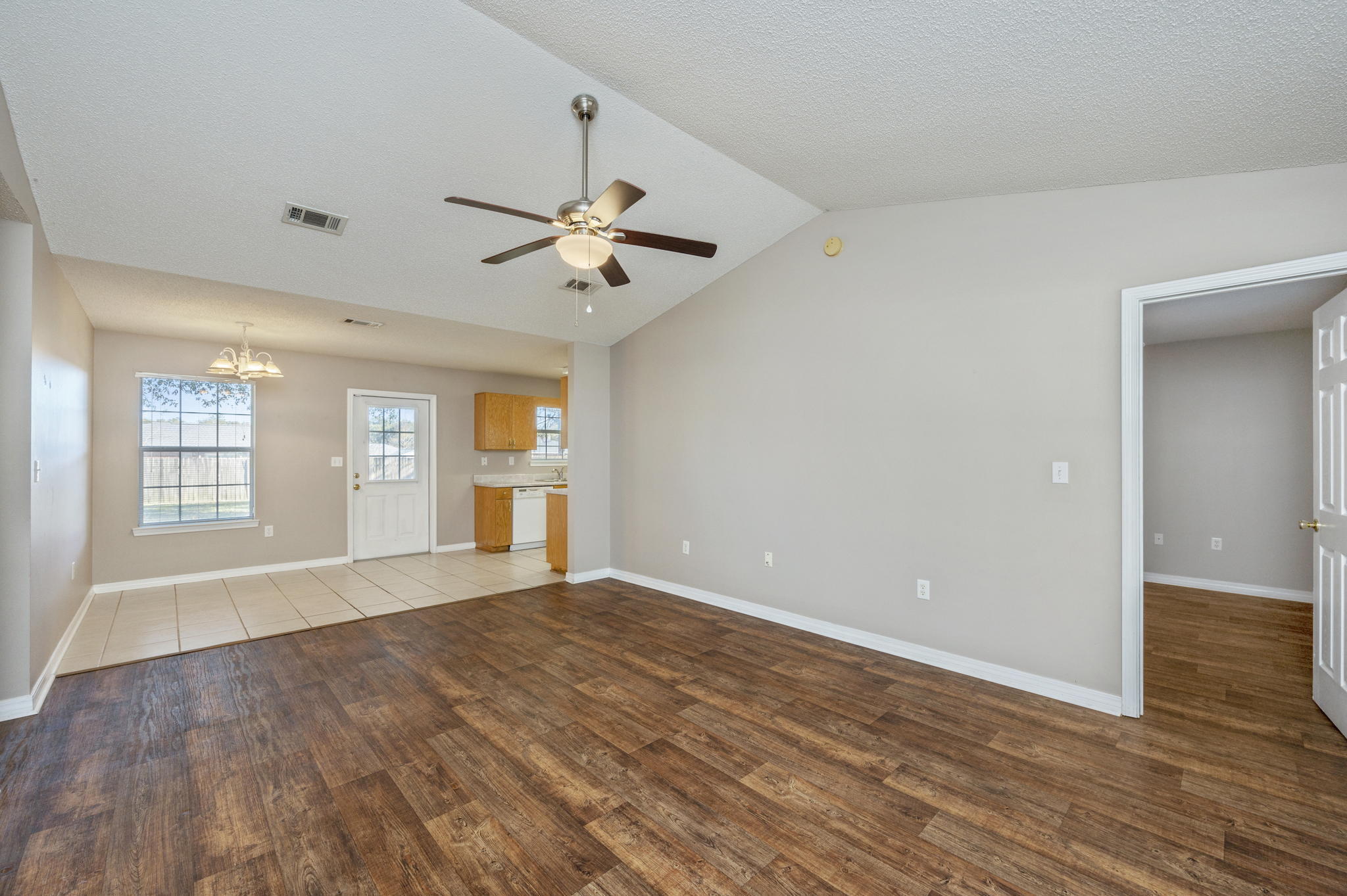 6235 Winstead Road Crestview, FL 32539 - Photo 4 of 31 a view of an empty room with a window and wooden floor