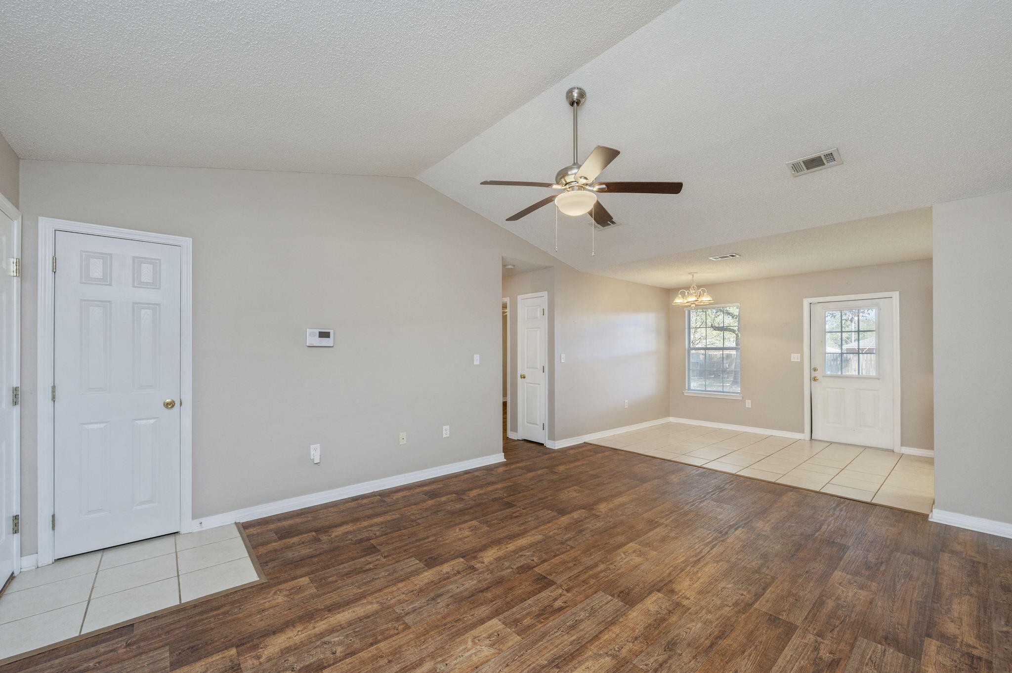 6235 Winstead Road Crestview, FL 32539 - Photo 5 of 31 a view of empty room with wooden floor and ceiling fan