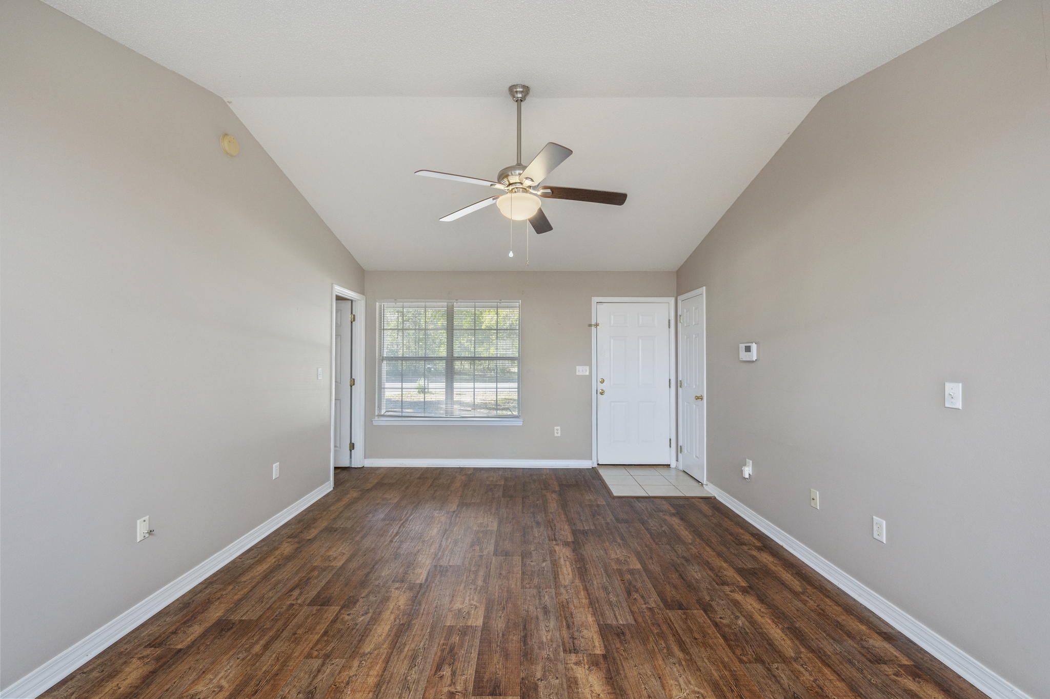6235 Winstead Road Crestview, FL 32539 - Photo 6 of 31 wooden floor in an empty room with a window