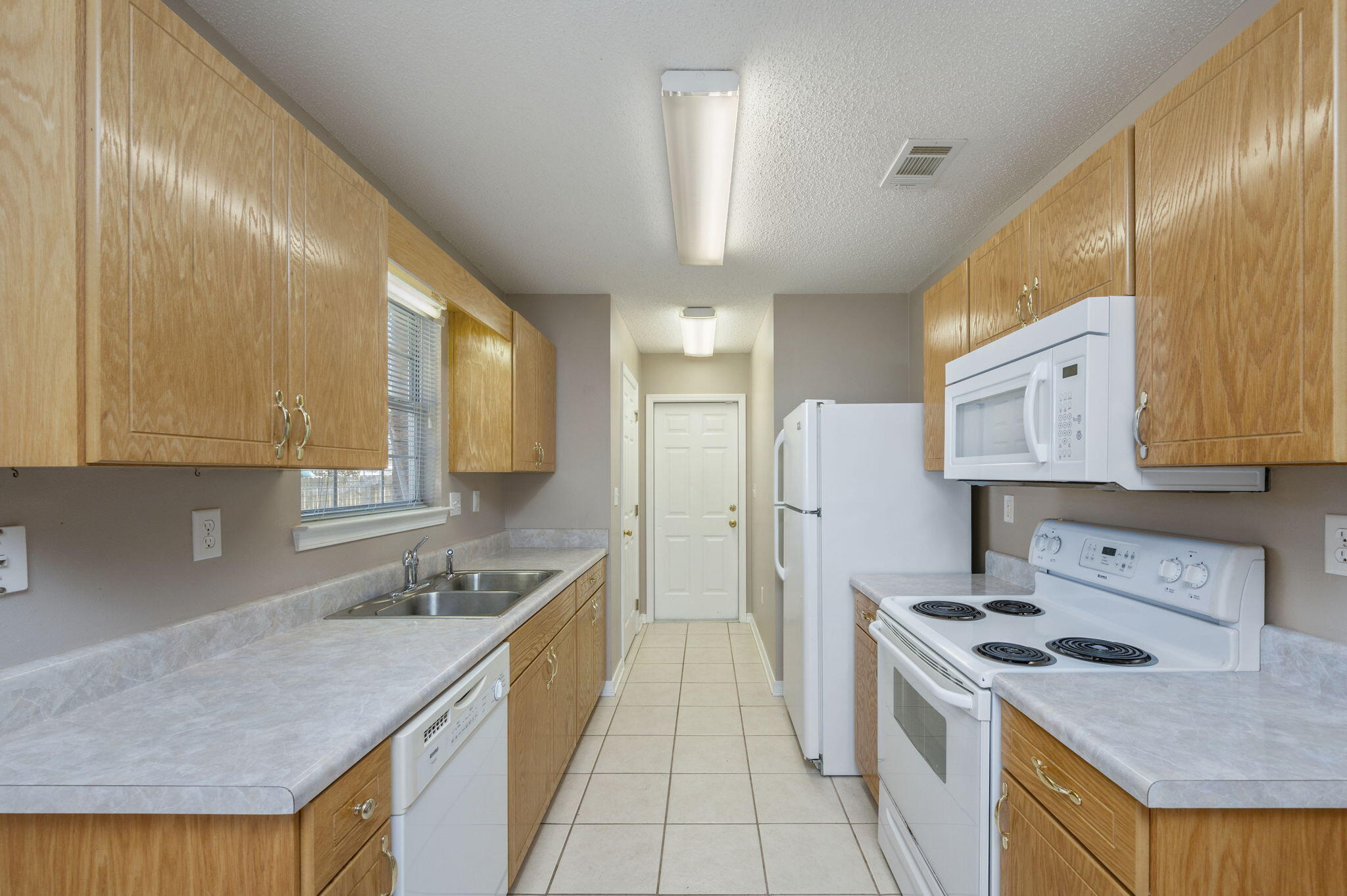 6235 Winstead Road Crestview, FL 32539 - Photo 8 of 31 a kitchen with a sink stove and refrigerator