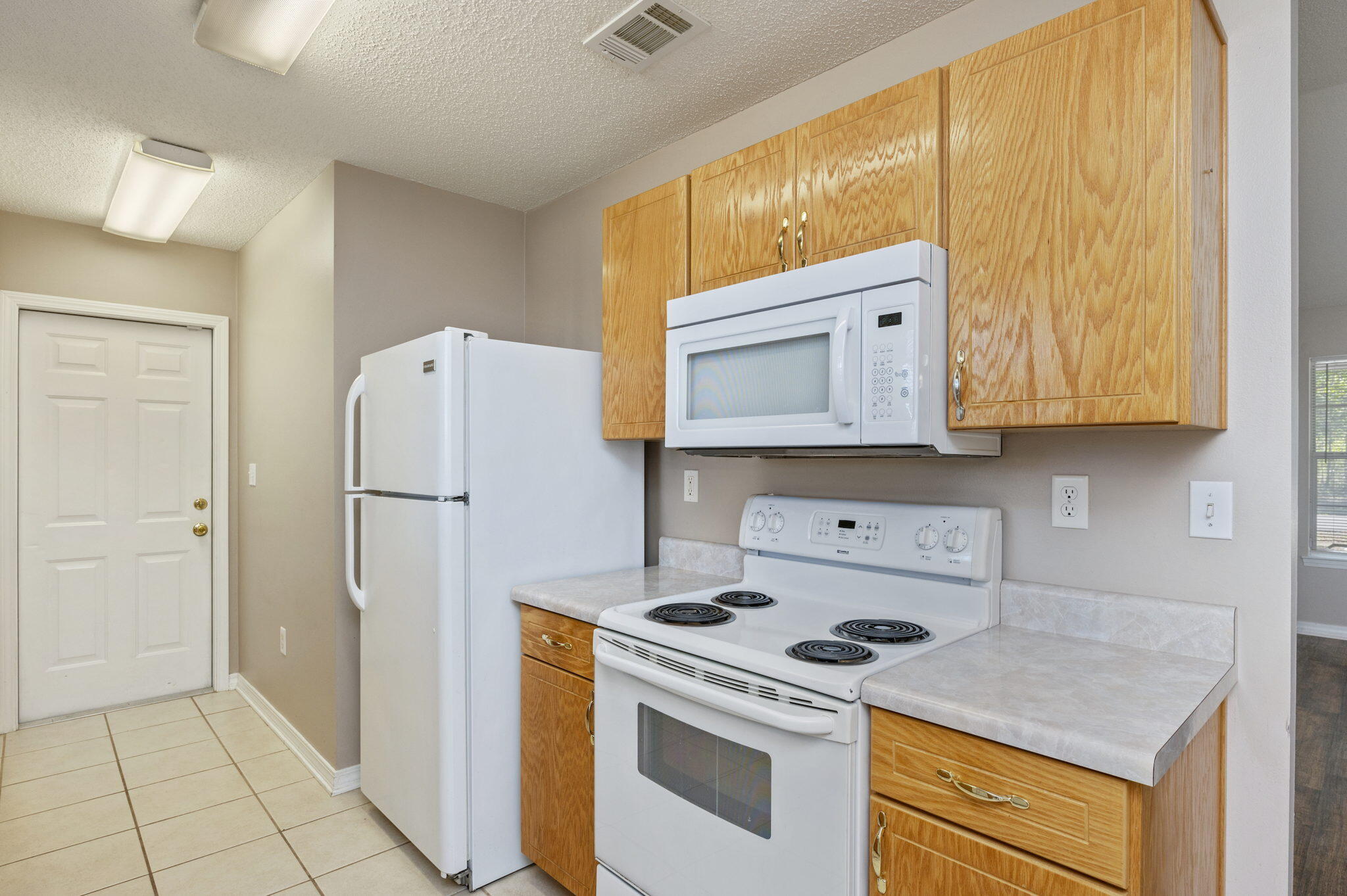 6235 Winstead Road Crestview, FL 32539 - Photo 10 of 31 a kitchen with a refrigerator sink stove and cabinets