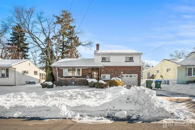 a view of a house with a snow in the yard