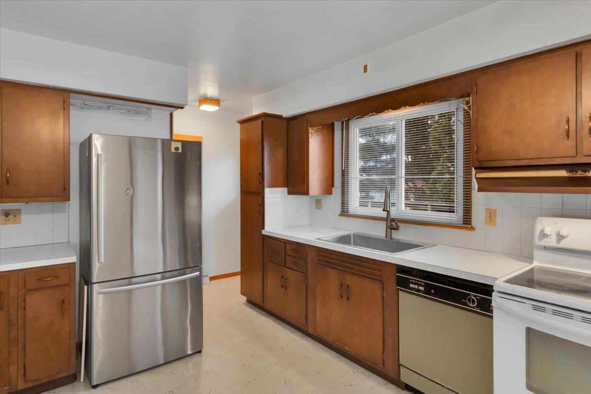 1636 Whitney Boulevard Belvidere, IL 61008 - Photo 14 of 36 a kitchen with stainless steel appliances granite countertop a refrigerator and a sink