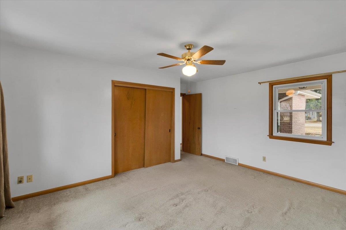 1636 Whitney Boulevard Belvidere, IL 61008 - Photo 17 of 36 an empty room with a window and a ceiling fan