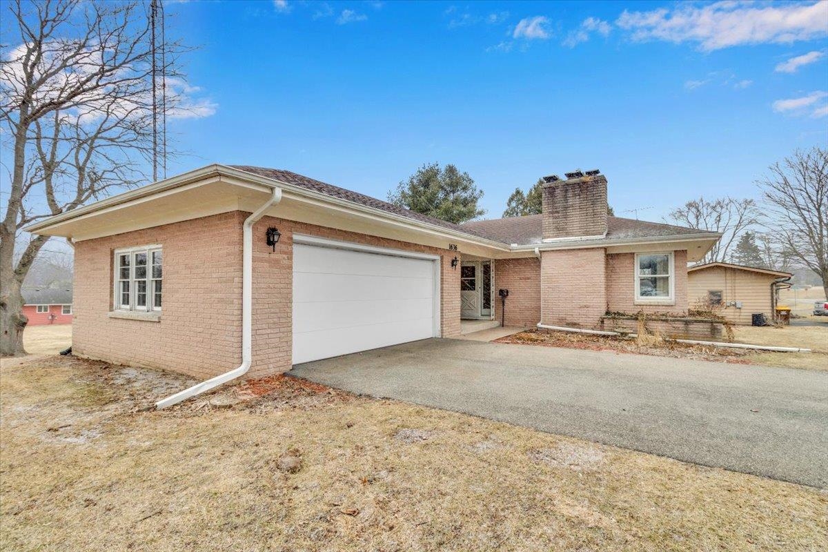 1636 Whitney Boulevard Belvidere, IL 61008 - Photo 4 of 36 a front view of a house with a yard