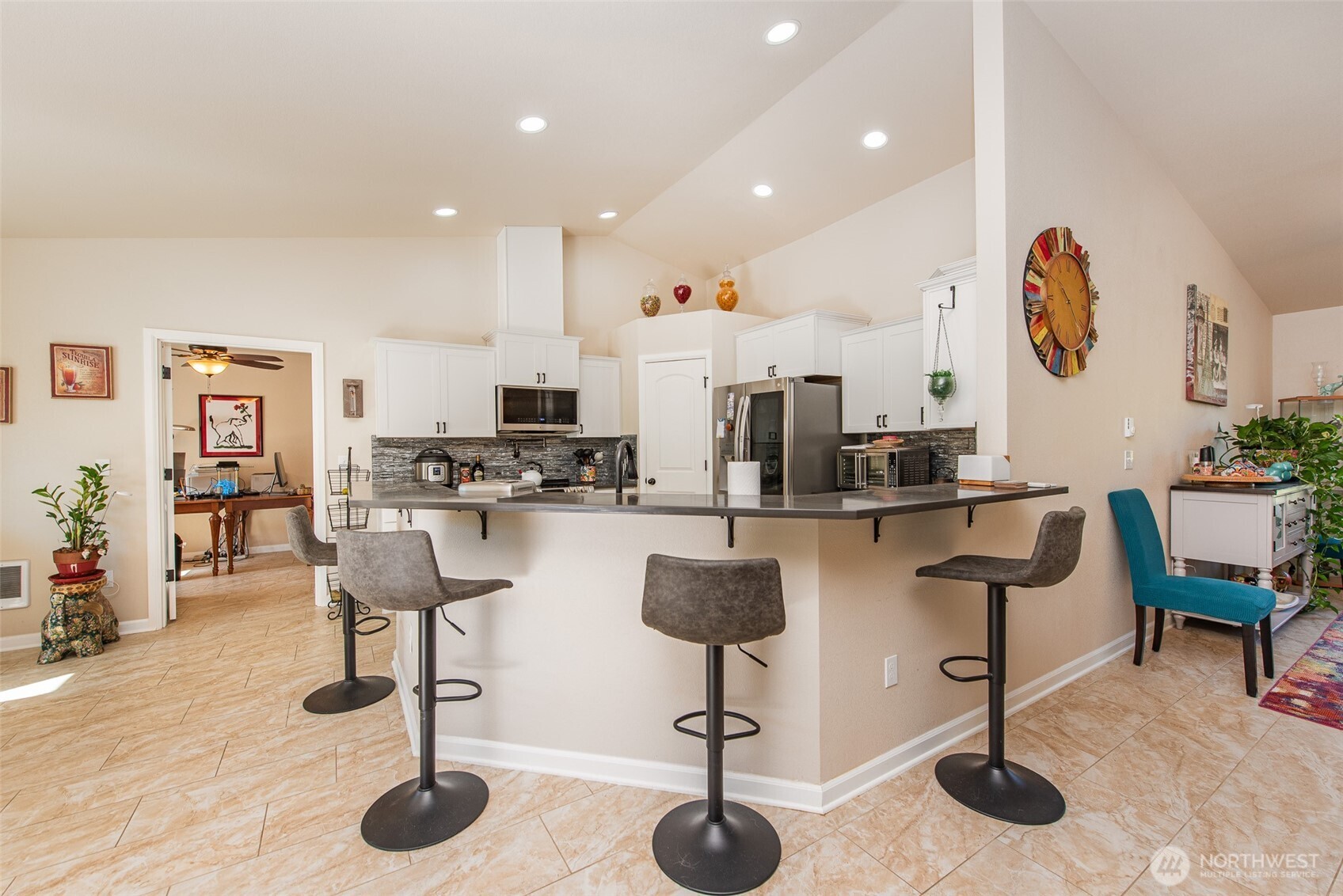 192 Michael Earl Way Sequim, WA 98382 - Photo 15 of 40 a kitchen with stainless steel appliances kitchen island granite countertop a table and chairs in it