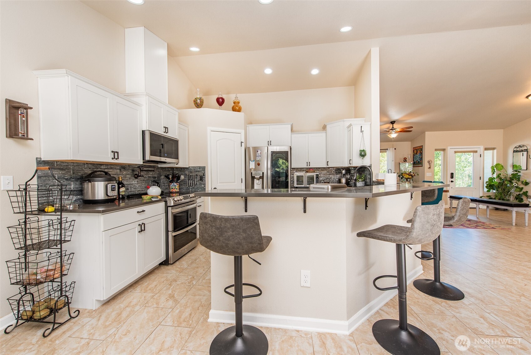 192 Michael Earl Way Sequim, WA 98382 - Photo 16 of 40 a kitchen with stainless steel appliances kitchen island granite countertop a stove a sink a oven and a dining table with wooden floor