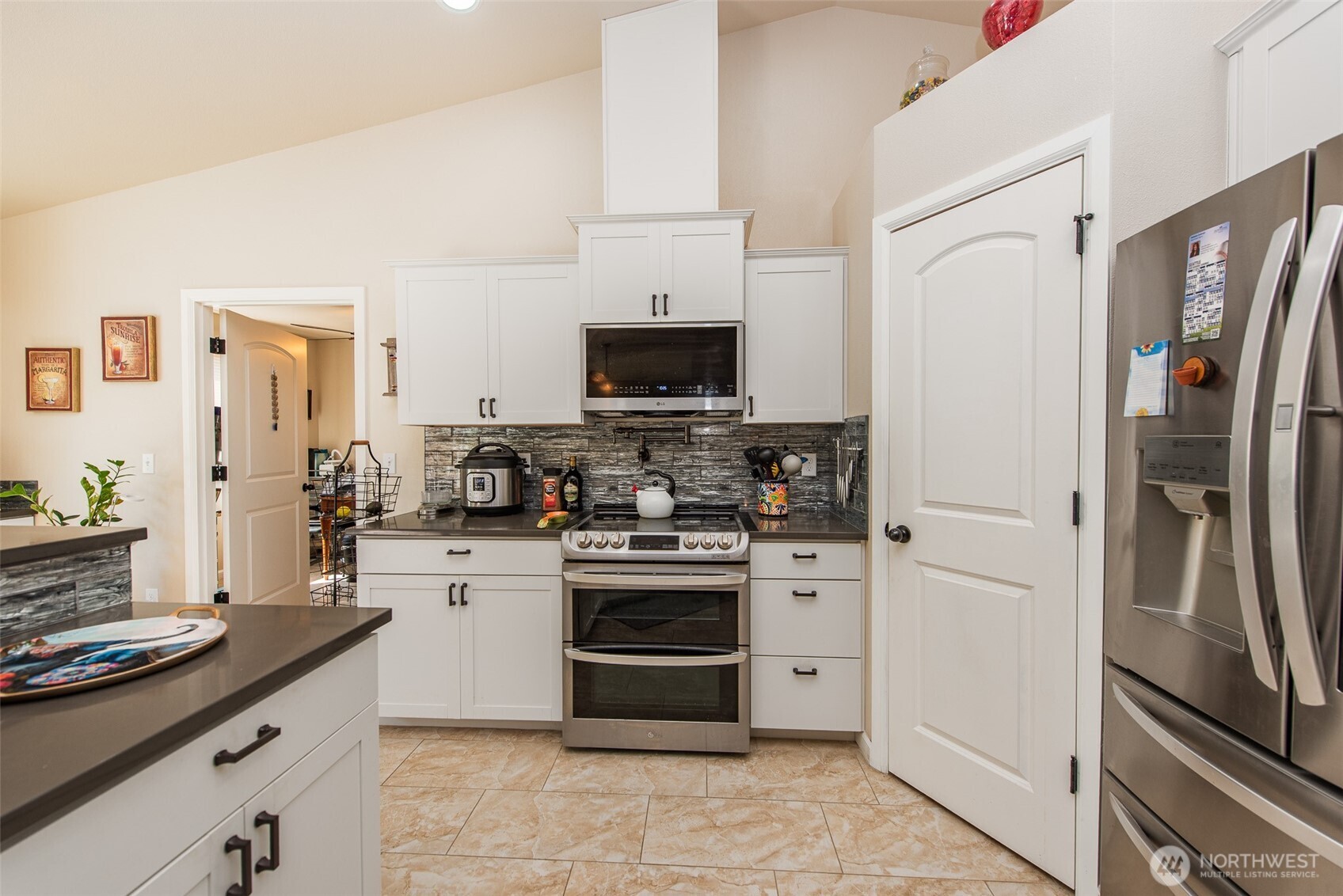192 Michael Earl Way Sequim, WA 98382 - Photo 21 of 40 a kitchen with stainless steel appliances granite countertop a refrigerator stove and sink