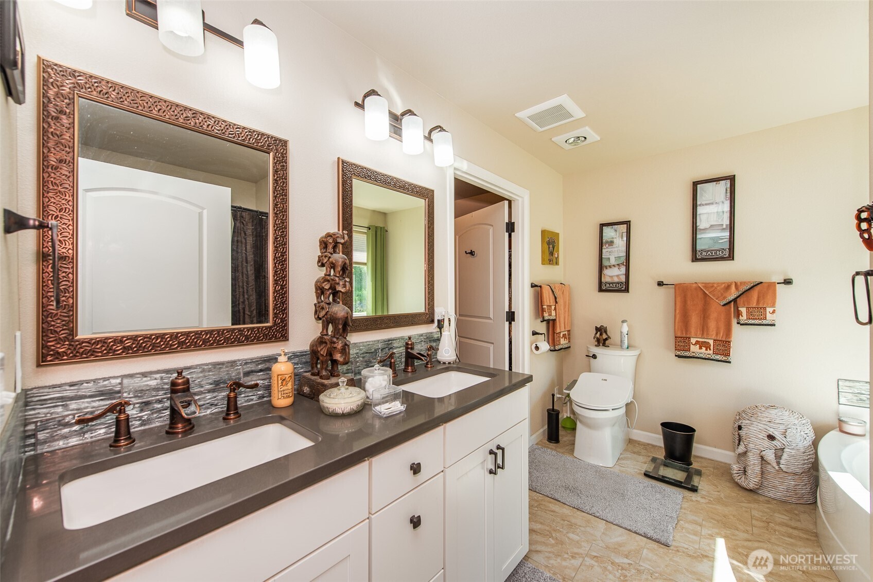 192 Michael Earl Way Sequim, WA 98382 - Photo 24 of 40 a bathroom with double vanity sinks a mirror and a shower