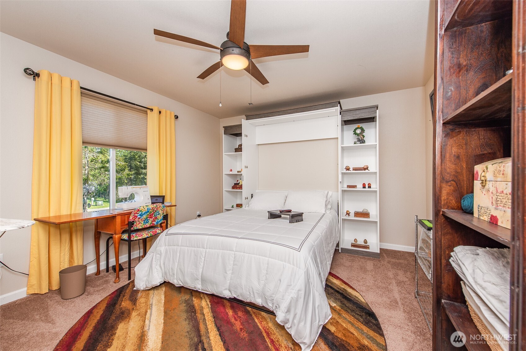 192 Michael Earl Way Sequim, WA 98382 - Photo 28 of 40 a bedroom with a bed and wooden floor