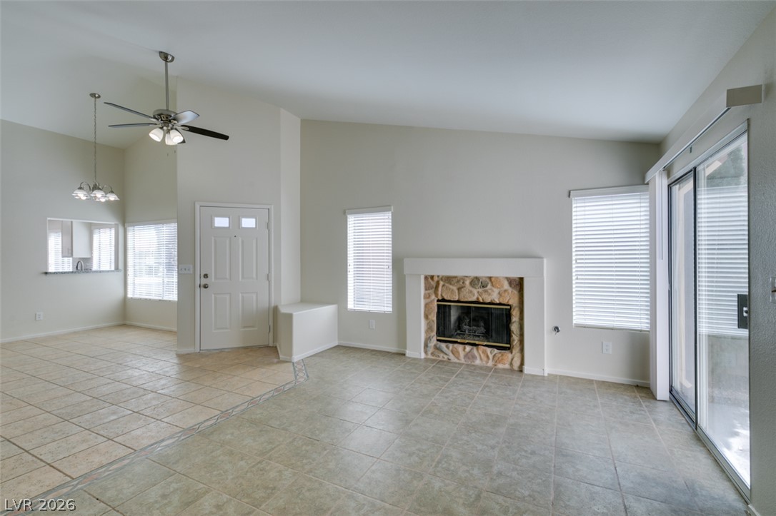 307 Cavalla Street Henderson, NV 89074 - Photo 10 of 44 A spacious living area features a charming stone fireplace and convenient outdoor access.