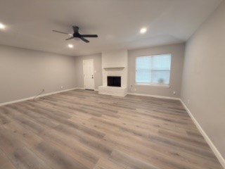 23918 Farm Hill Drive Spring, TX 77373 - Photo 2 of 16 an empty room with windows and fireplace