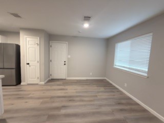 23918 Farm Hill Drive Spring, TX 77373 - Photo 4 of 16 a view of an empty room with wooden floor and a window
