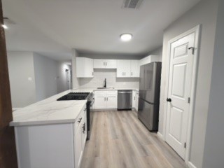 23918 Farm Hill Drive Spring, TX 77373 - Photo 6 of 16 a kitchen with a sink a refrigerator and cabinets