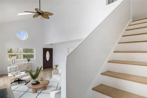 a view of an entryway with wooden floor and fan