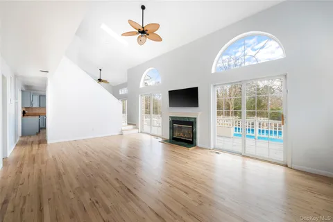 wooden floor in an empty room with a fireplace