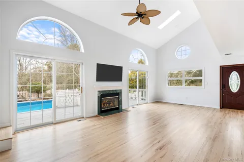 a view of livingroom with window fireplace and wooden floor