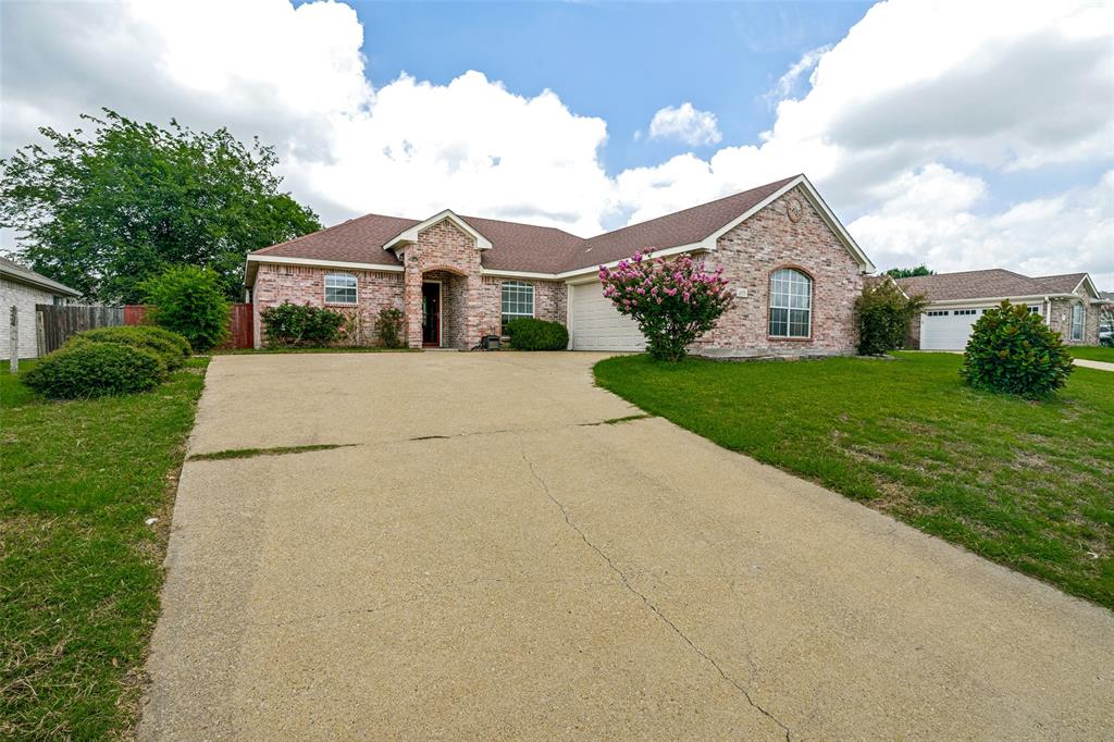 3111 Creekside Drive Sachse, TX 75048 - Photo 2 of 25 Traditional-style residence featuring a brick facade with stone accents, a multi-gabled roofline, and a concrete driveway
